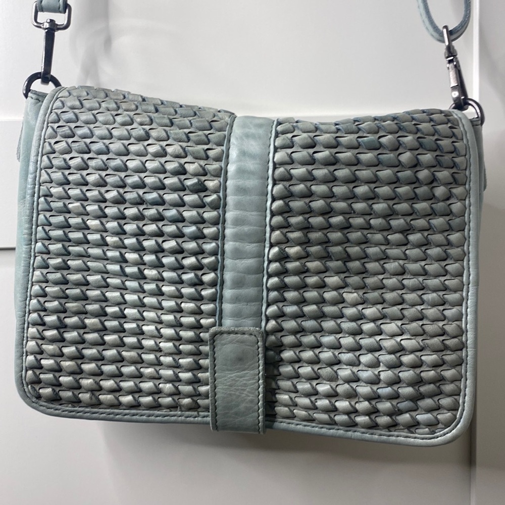 Teal genuine leather purse. Worn once. Strap length is adjustable.